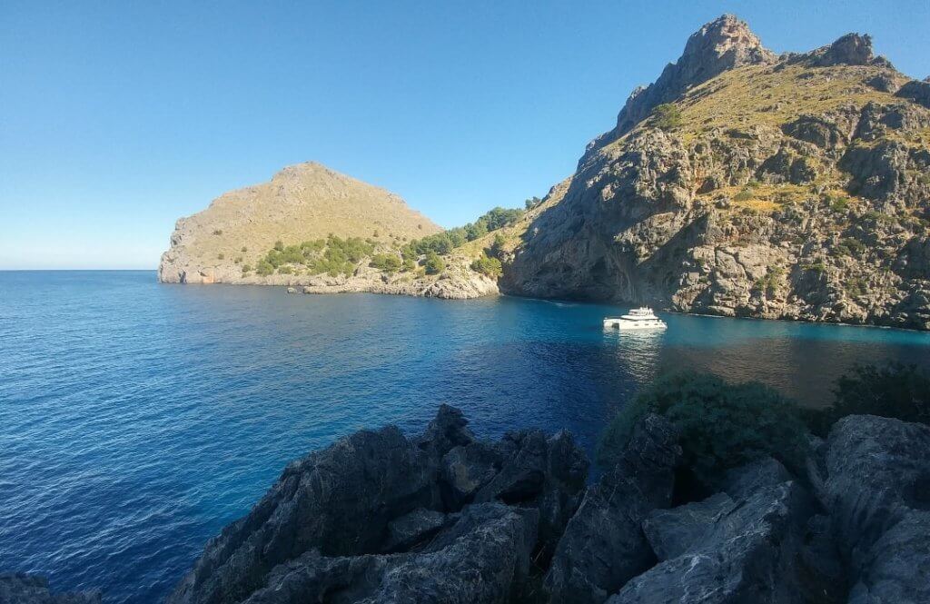 A Day Trip Around Mallorca, rocky beach, catamaran, Mediterranean sea