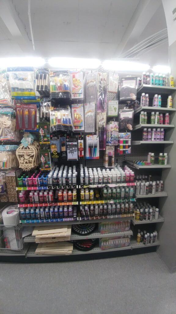 Pain and brushes in an aisle, travel essentials to buy at the Dollar Store