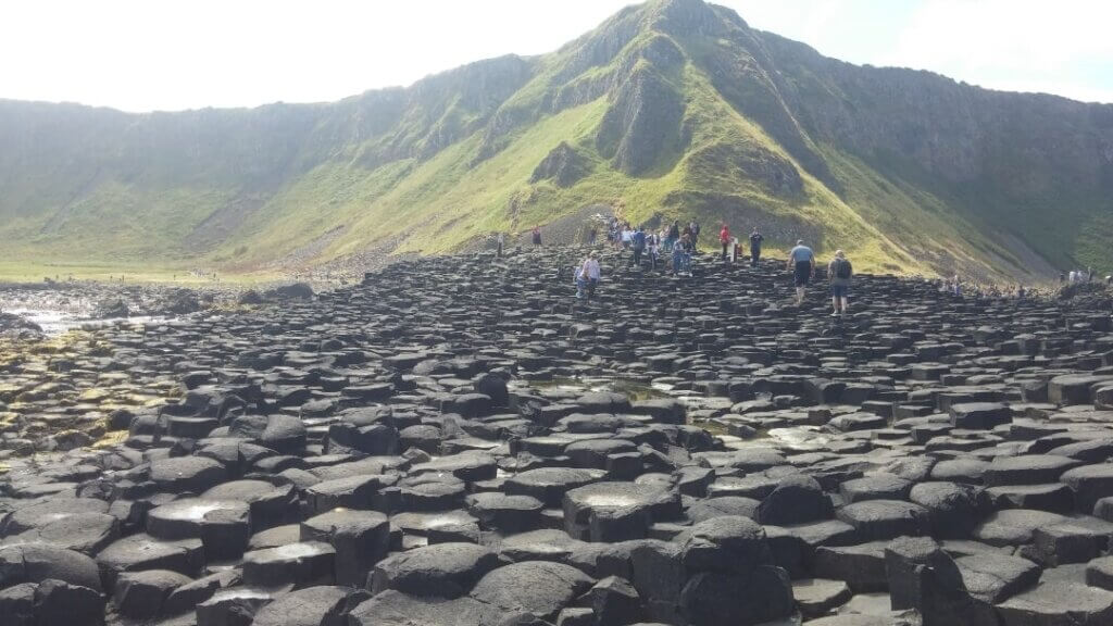 People hopping up and down the hexagon formations in the Giant's Causeway