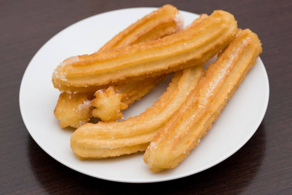 Plate of churros, churros, Spanish food, desserts, breakfast, Foods & drinks to try in Spain