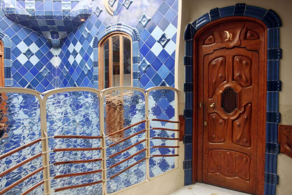 The interior of Casa Batllo, blue tiles and a wooded door, Barcelona attraction, The inside of Casa Batllo