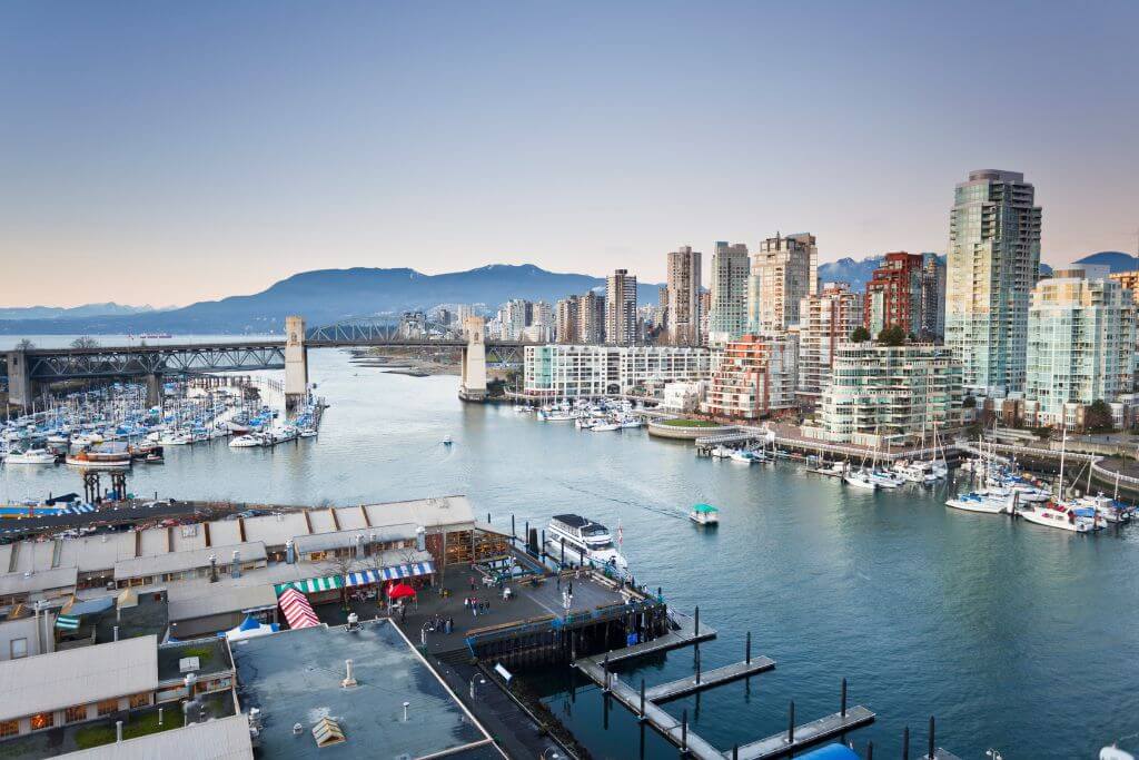 View of Vancouver City to the right and Granville Island to the left, bridge, mountains
