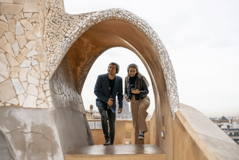 A couple exploring Casa Mila with the Audio Guide, Barcelona attractions 