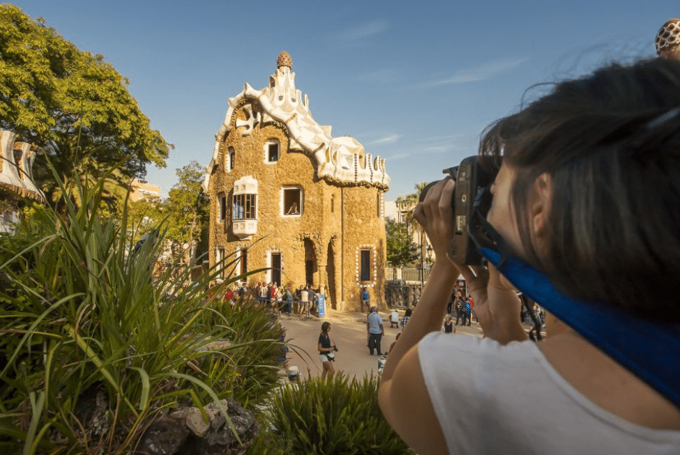 A girl taking a picture in Park Guell, attractions in Barcelona, Gaudi Barcelona Tours 