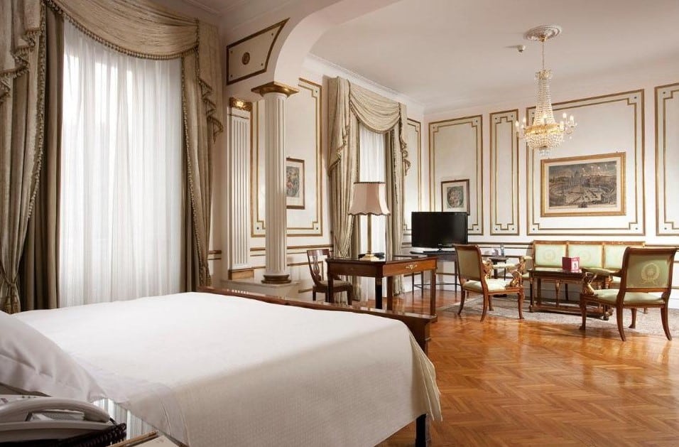A room in Hotel Quirinale, bed, desk, parkette floor