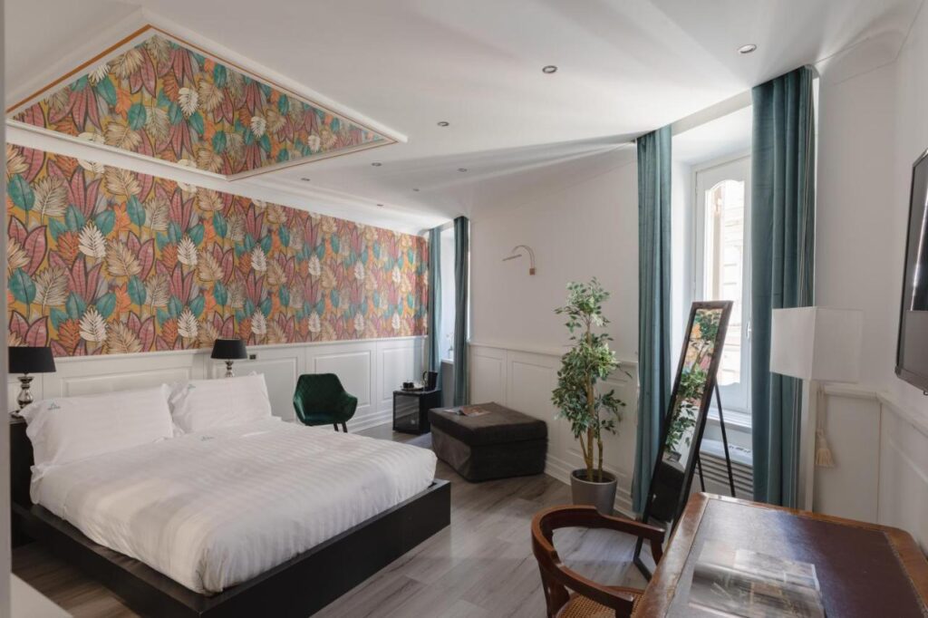 Relais Roma Centro room, bed, desk, mirror, Trevi Fountain accommodations
