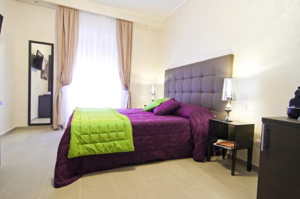 Domus Fontis room, purple decor, large bed