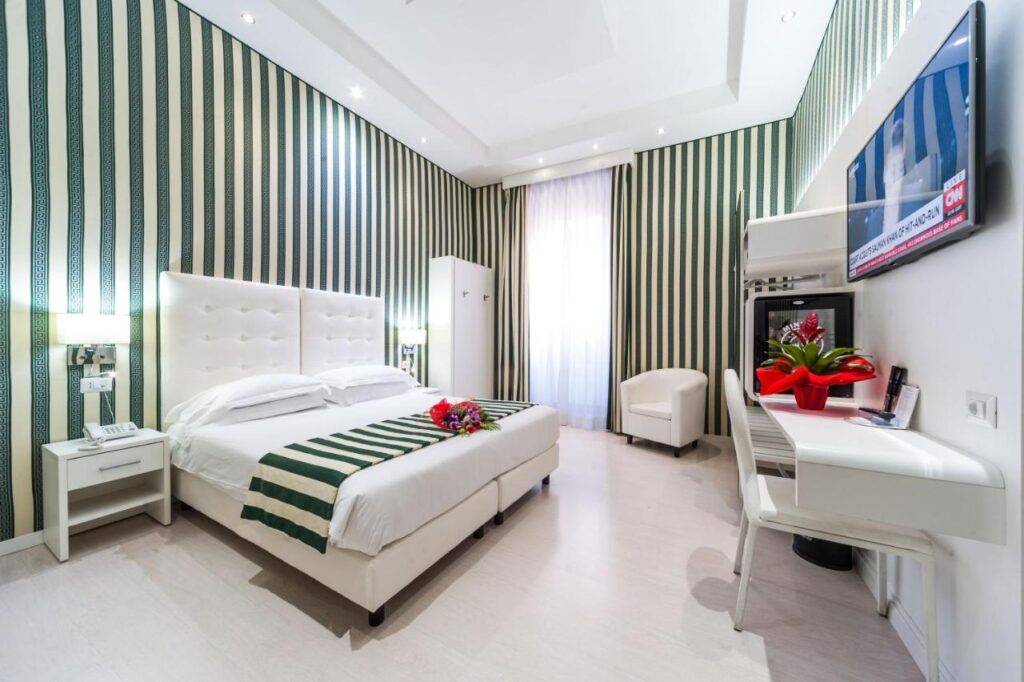 Relais Trevi 95 Boutique Hotel room, white decor, large bed, tv