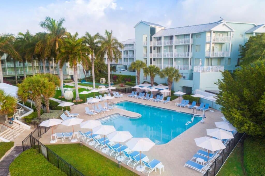 The Reach Key West, Curio Collection by Hilton, pool, chairs, palms