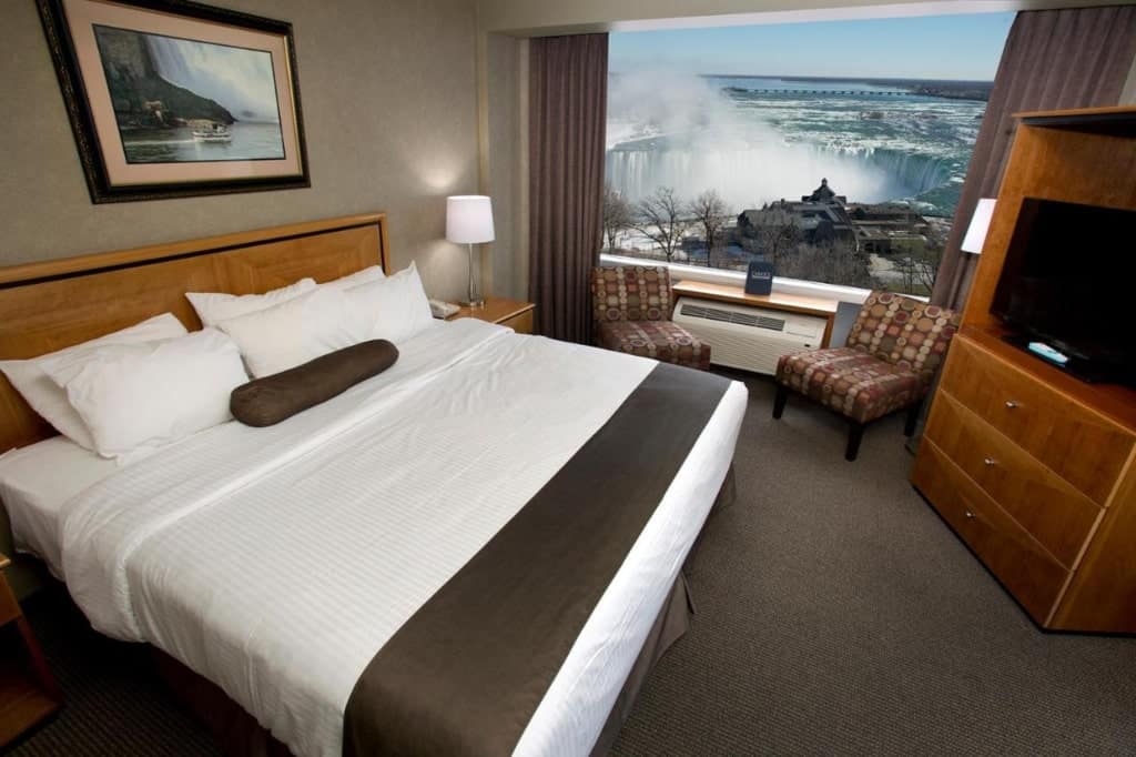 A room in Oakes Hotel Overlooking the Falls, a dresser, tv, large window