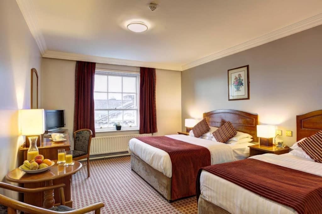 A room in Cassidys Hotel, two large beds, fruit on a small table, Dublin Hotels Near Croke Park