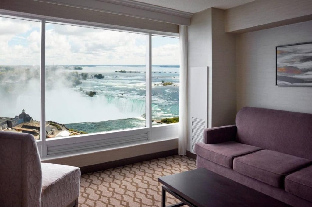 A room in Niagara Falls Marriott Fallsview Hotel & Spa, a sofa, a chair, large window with a view