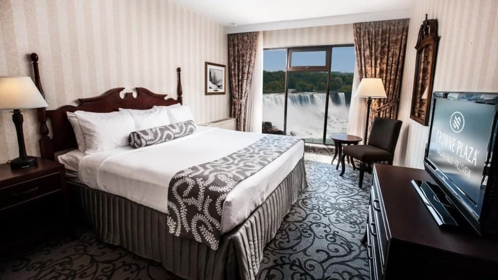 A room in Crowne Plaza Hotel-Niagara Falls/Falls View, an IHG Hotel, a large bed, large window, tv