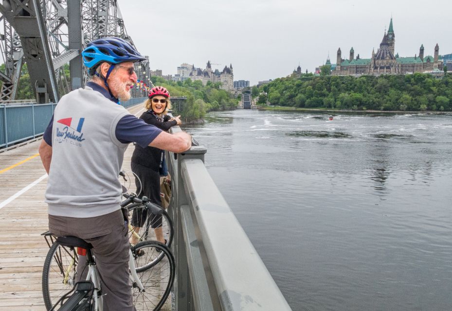 An older couple on a bridge biking beside a river, Ottawa biking, Ottawa Bike Tours