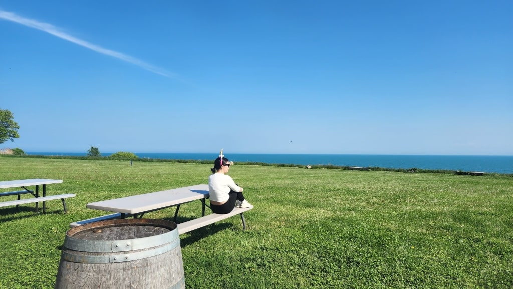 View of Lake Erie from Viewpointe Estate Winery, me sitting on a bench, lakeviews, wineries