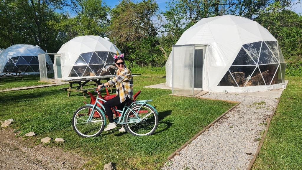 Me biking with some of the larger domes behind me, bike, unicorn, large domes, retreat
