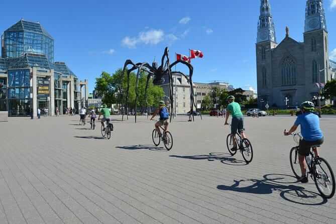 A group of tourists doing a bike tour beside the National Gallery of Canada, Rent bike Ottawa 