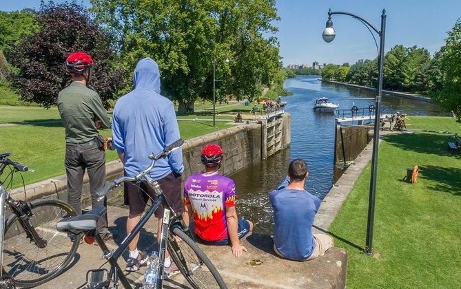 A group of men sitting and enjoying Rideau Canal in Ottawa