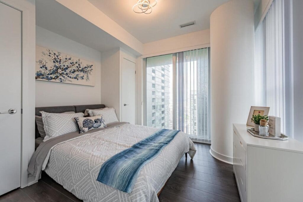 Bedroom in a condo, large bed, modern design, large window