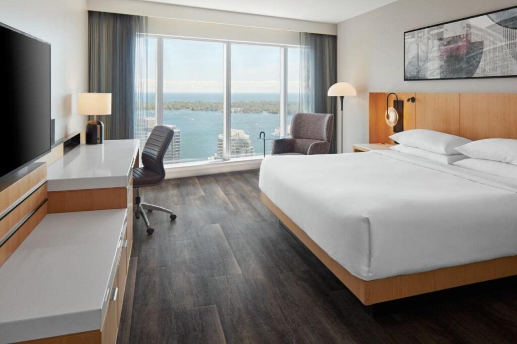A lake view room at Delta Hotels by Marriott Toronto, hotel room, large bed with white sheets
