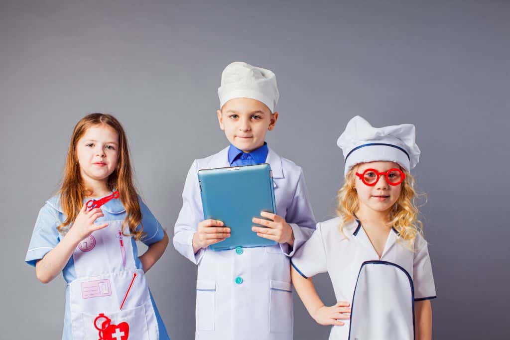 KidZania, kids playing different occupations, three white kids