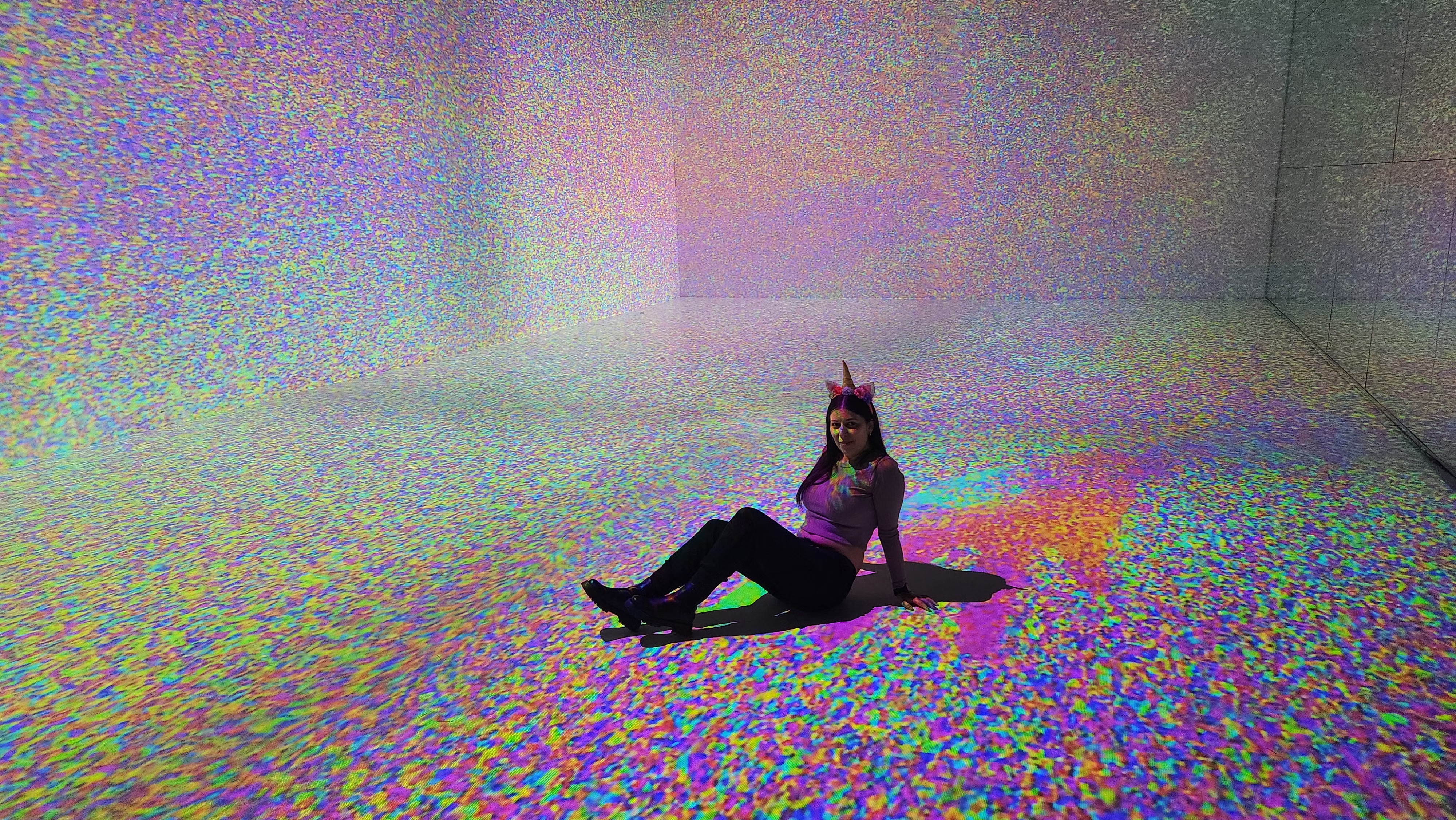 A girl sitting on the floor in Arcadia Earth, posing, art instalation