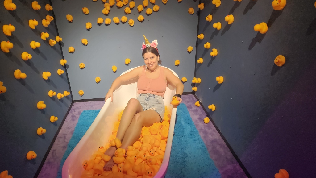 A girl in a bath tub full of yellow rubber duckies, Bubble Planet