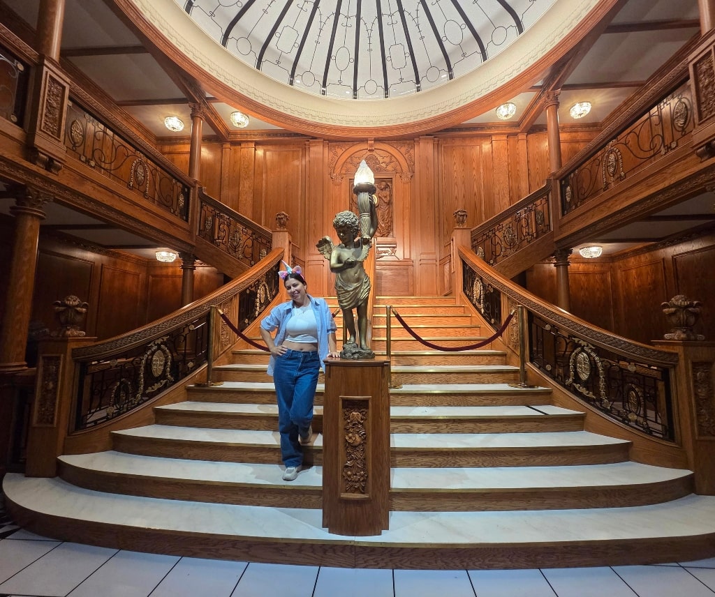 A girl standing in front of the Grand Staircase, Titanic: The Artifact Exhibition