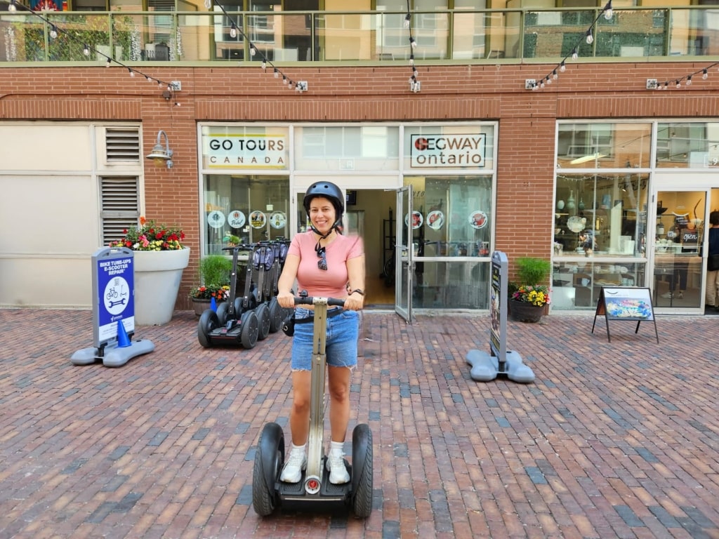 A girl with a helmet on a Segway, guided tour, Distillery District