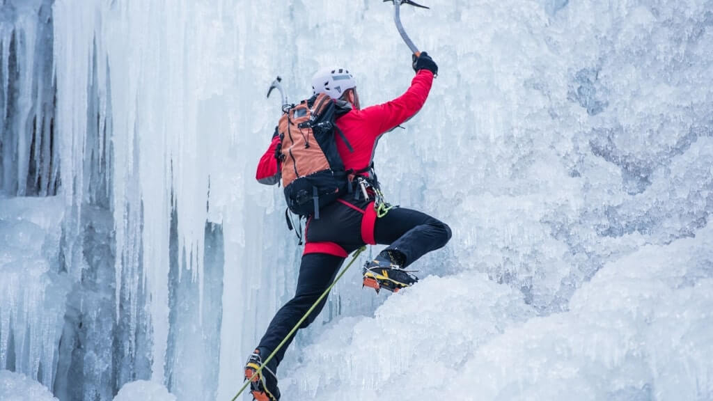 Ice Climbing, a man ice climbing a frozen waterfall