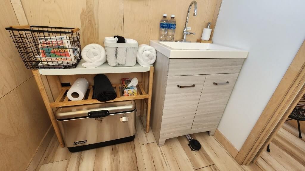 storage room, sink, towels, small room, Meridian63° Luxury Camping Review