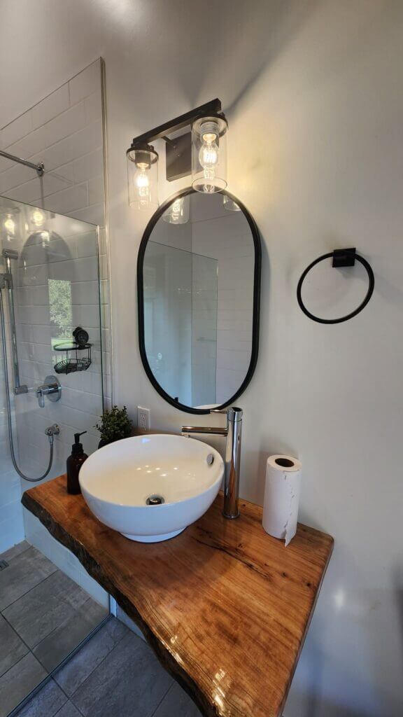 Luxury bathroom, white sink, wooden vanity, wall mirror