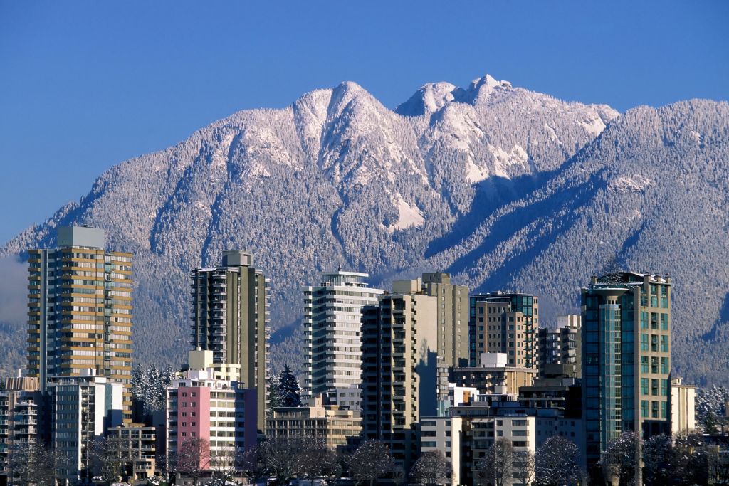 Vancouver in the winter, snowy mountain, tall building 