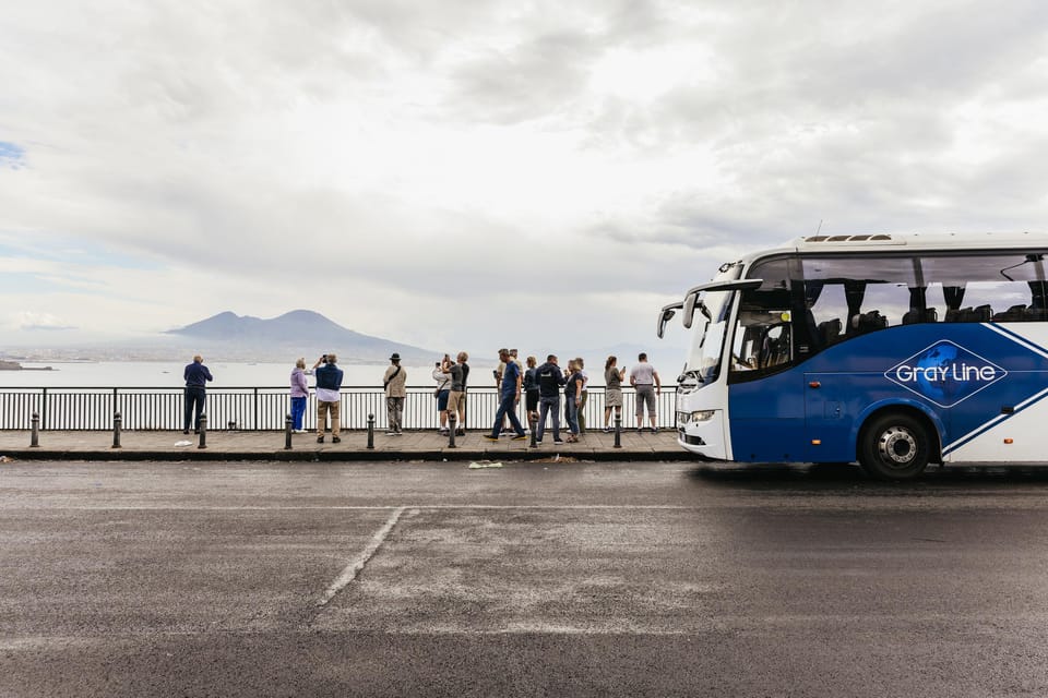 A group of tourists, a tour bus