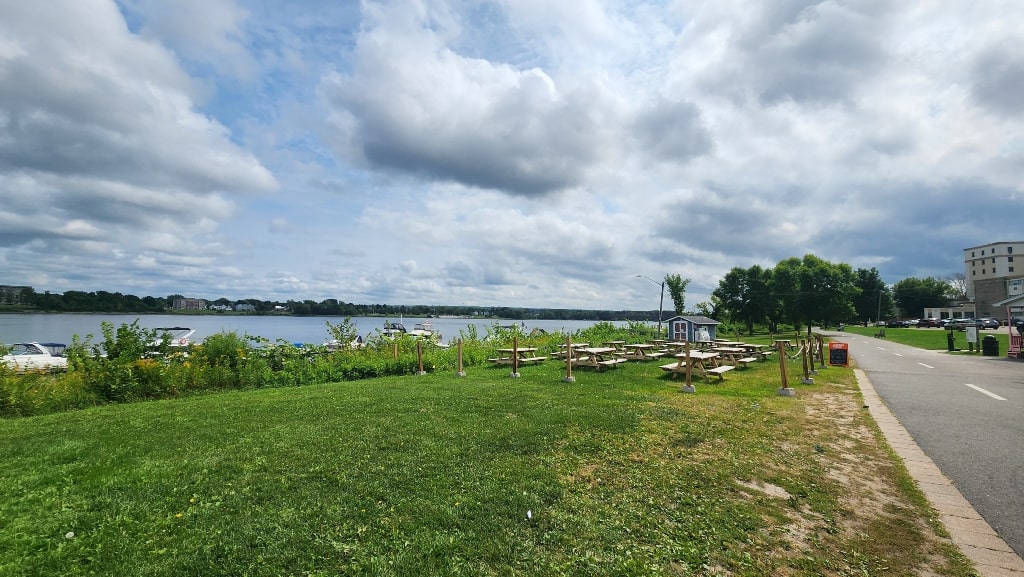 The waterfront and the picnic benches beside Lighthouse By 540. There is a cute ice cream shop beside it