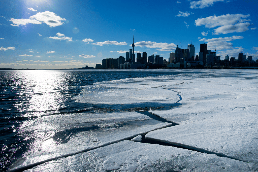 View of Toronto from Toronto Island in the winter, frozen Lake Ontario, sunny dat