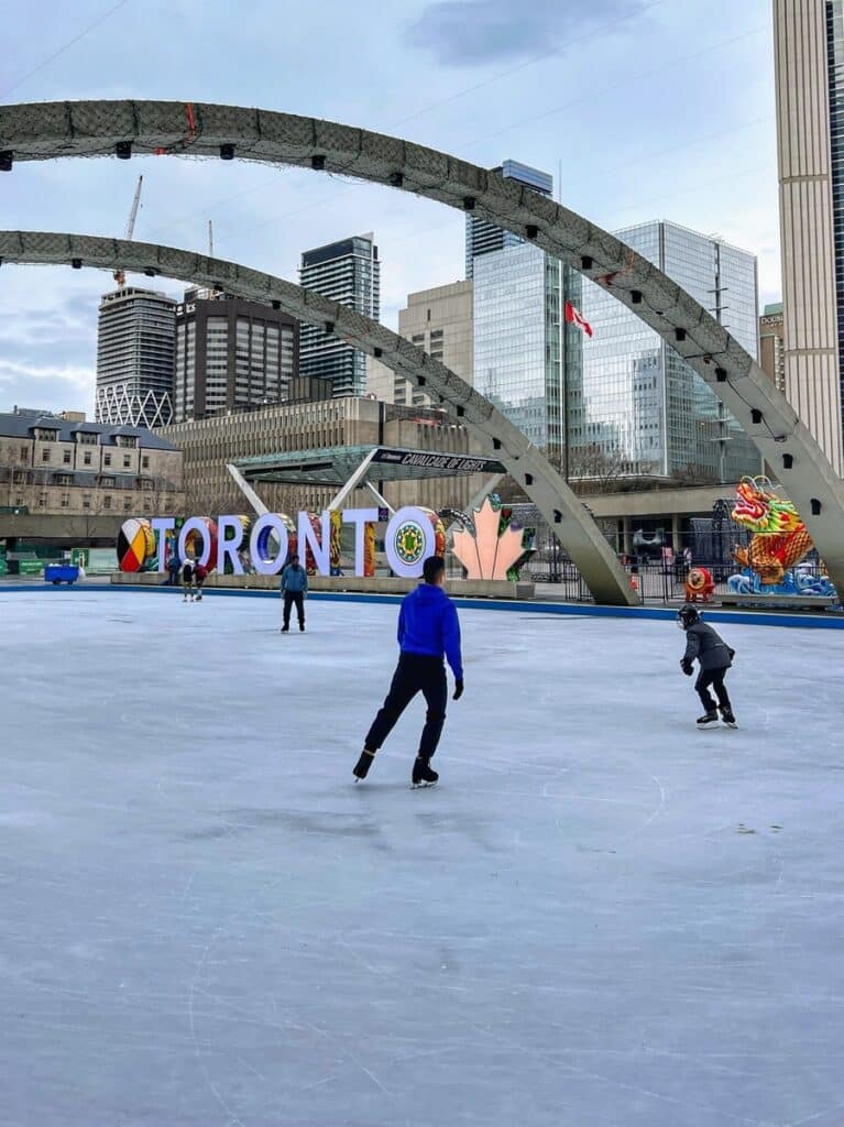 Toronto Sign in winter with skaters, Toronto, Ontario