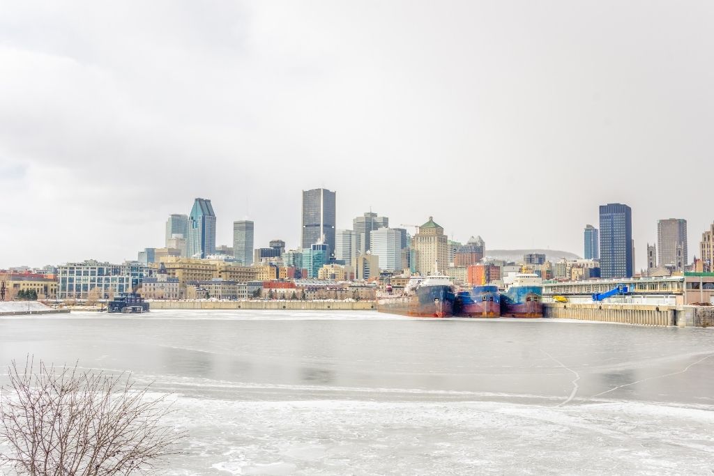 View of Montreal in winter, frozen river, city in Quebec