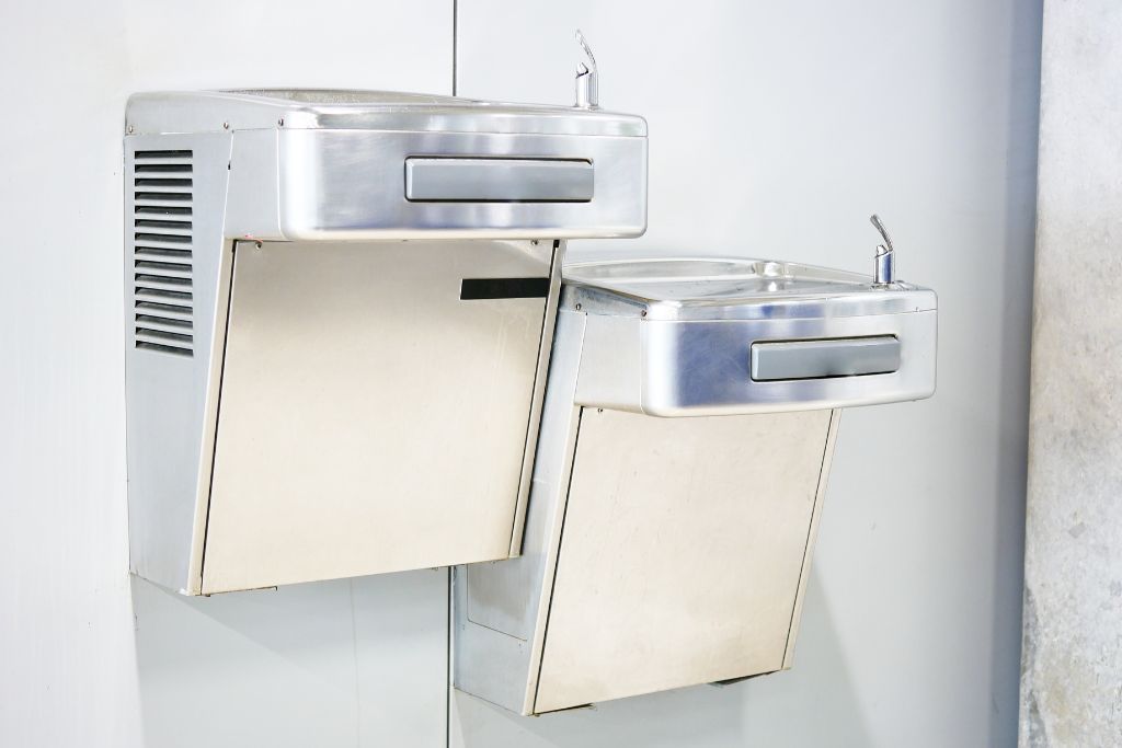 Two water fountains in an airport, most modern airports now have filtered water refill stations near restrooms or gate areas, so take a few minutes to top up