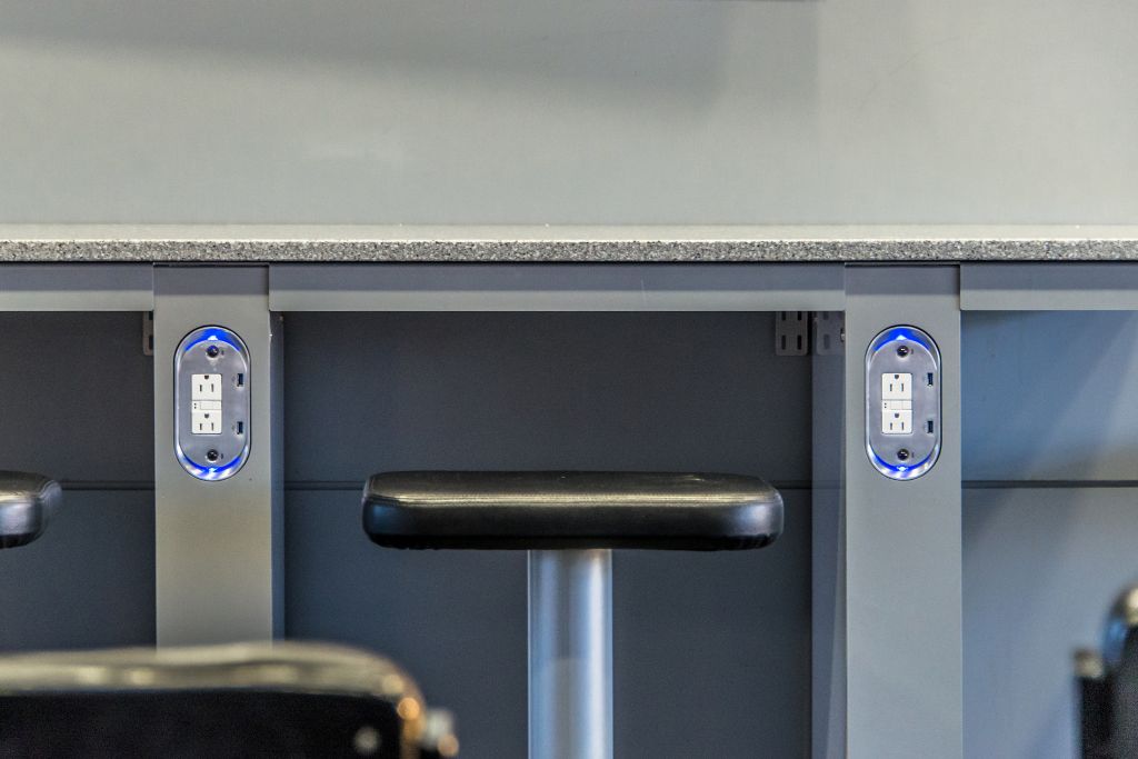 Charging outlets in an airport, once you find your gate, find a spot near a charging station and plug in your devices, Things To Do Right After Airport Security
