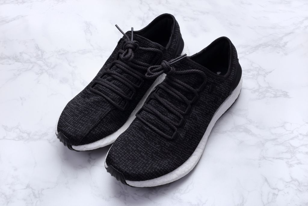 A pair of black sneakers, black running shoes