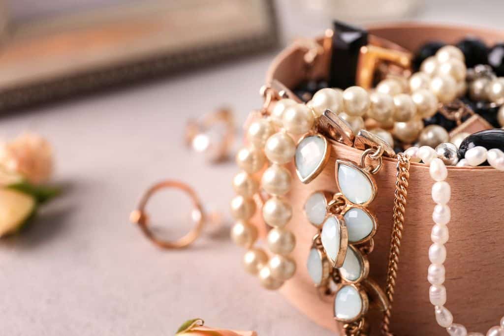 A close up of a bag with jewelry, accessories in a box