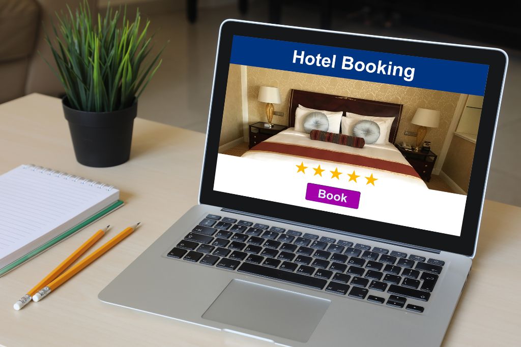 A laptop on a desk, open on a hotel booking website, one of the tips of how to travel more for less is to switch to incognito mode