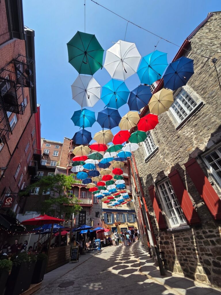 Umbrella Alley – a whimsical pedestrian lane where colorful umbrellas suspended overhead create a playful and Instagram-worthy canopy.