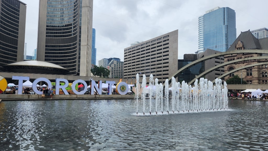 Nathan Philips Square with the Toronto sign and City Hall, fountain