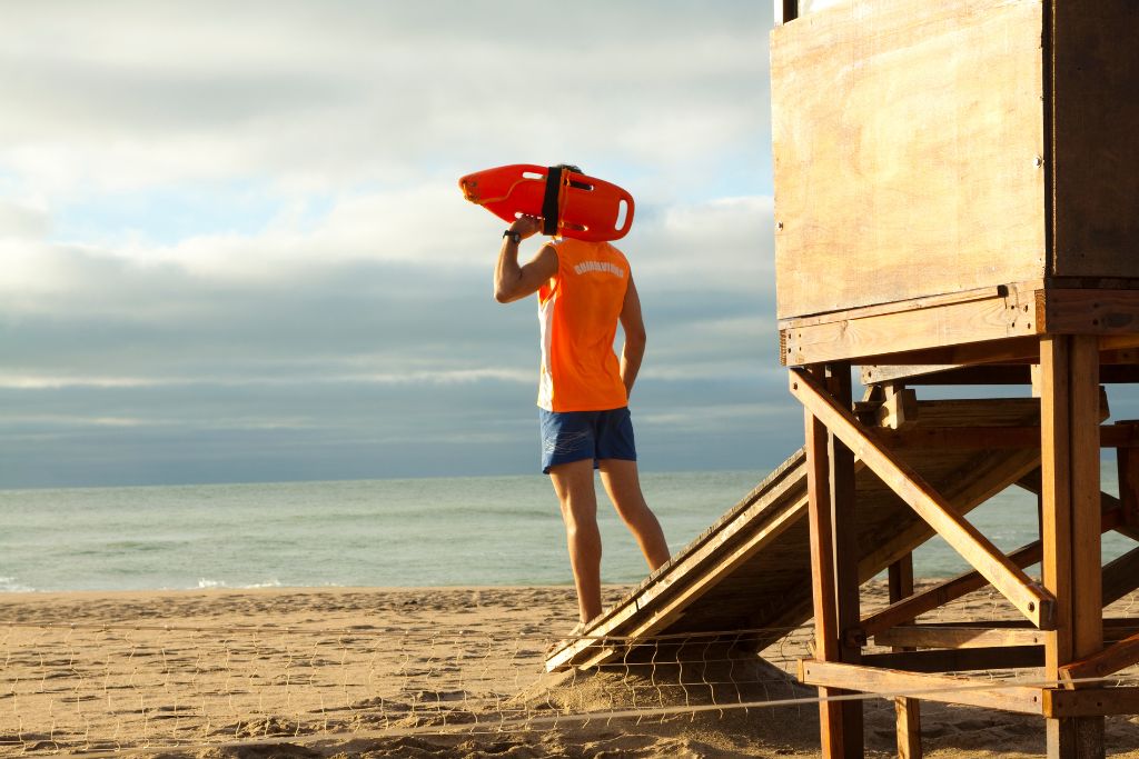 A male lifeguard who is observing the ocean