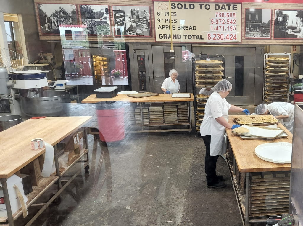 The staff of the Big Apple preparing some fresh apple pies, roadside attraction