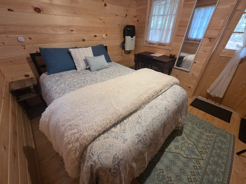 Inside the White Pine Haven (Bunkie), cozy cabin with a bed