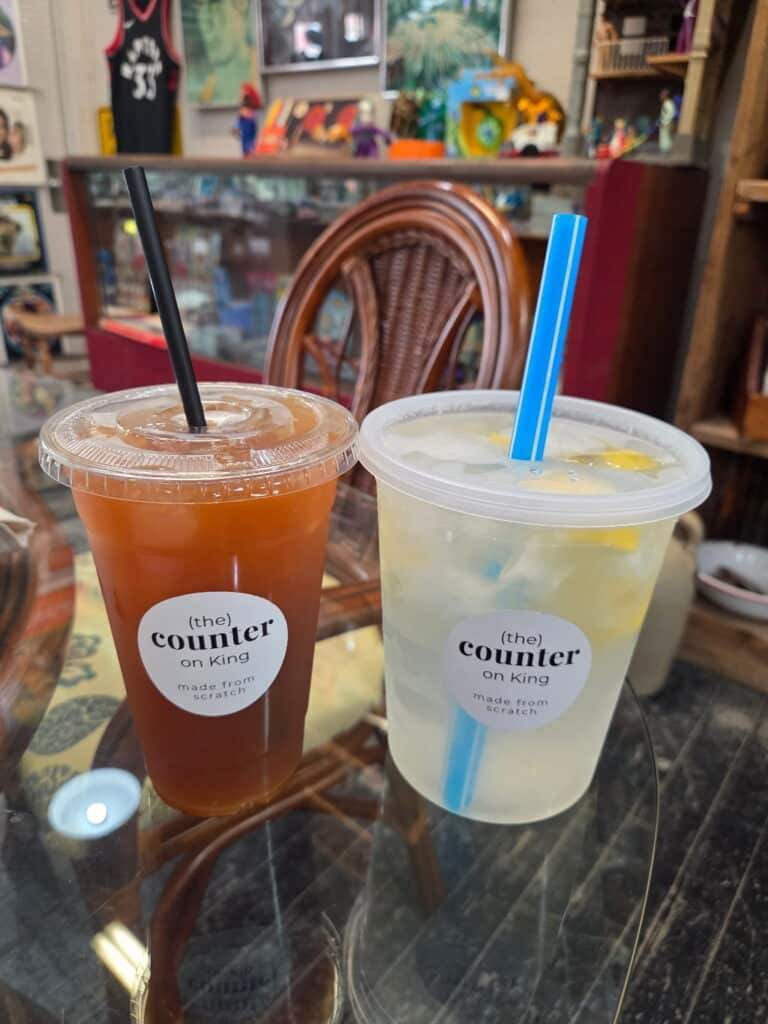 Homemade lemonade and sweet iced tea, two large drinks on a table