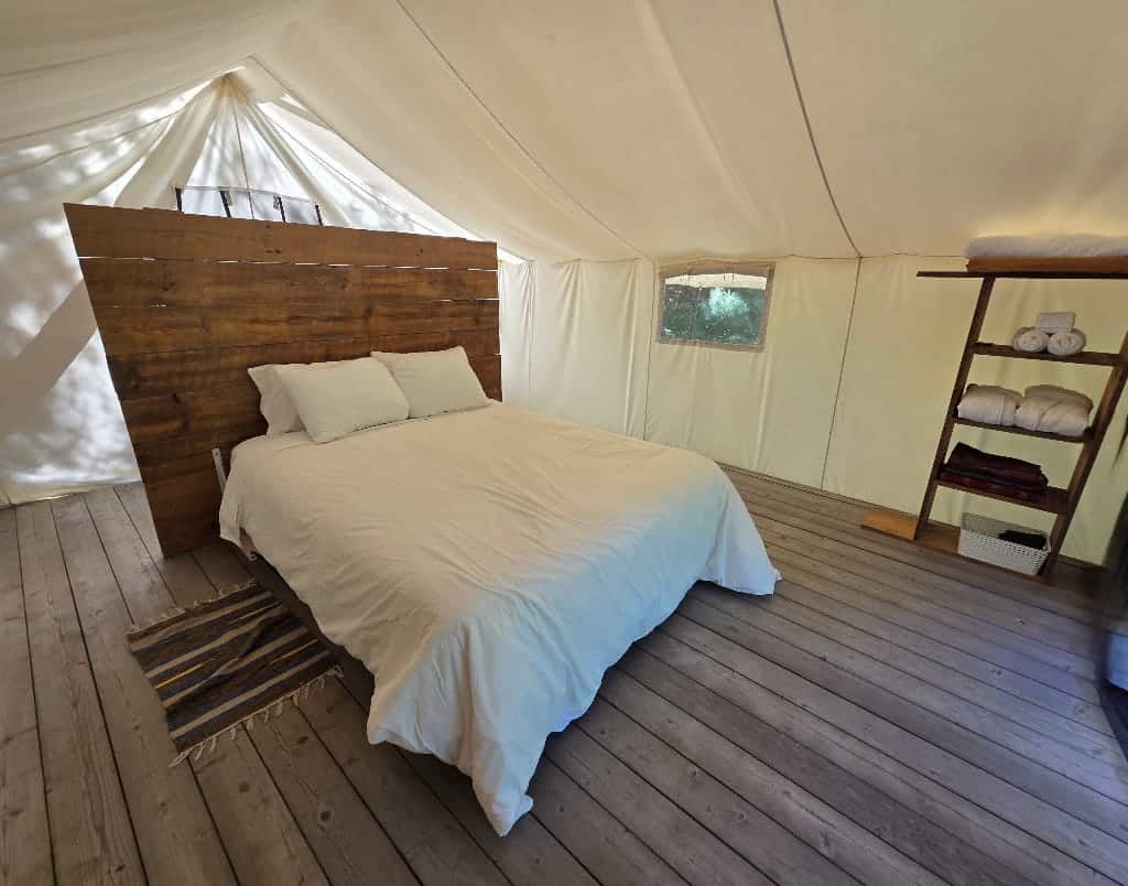 The hotel-style bed in the tent